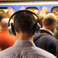 A rush hour commute scene with someone wearing poor quality headphones (1).jpg